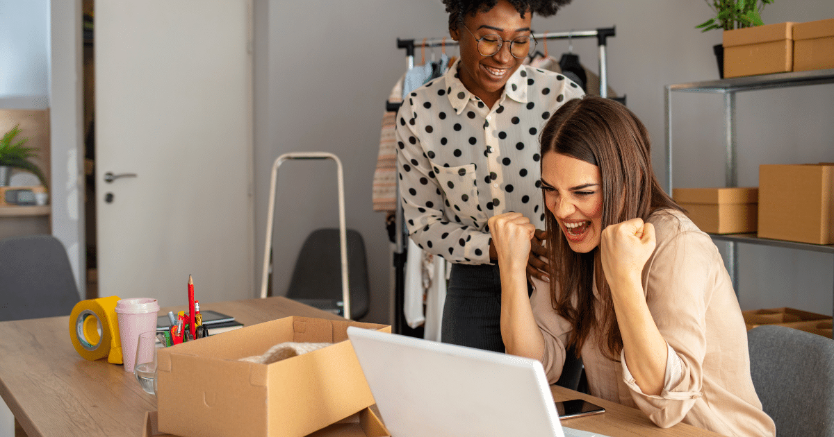 Women celebrating business success with unsecured loans in a modern workspace, highlighting growth and opportunity.