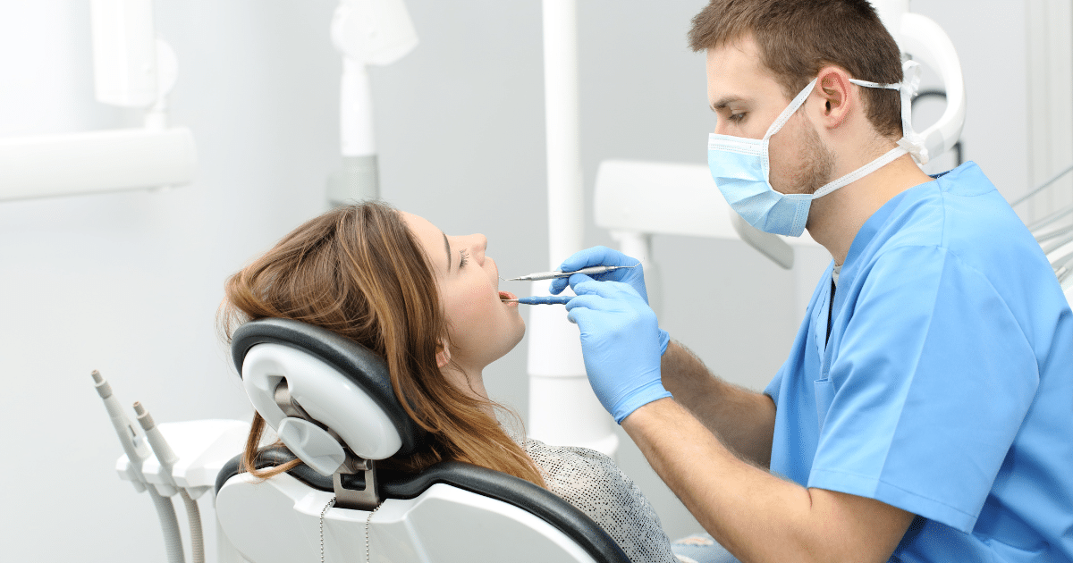 Dentist providing care to a patient in a dental office, highlighting flexible financial solutions for dental practices.