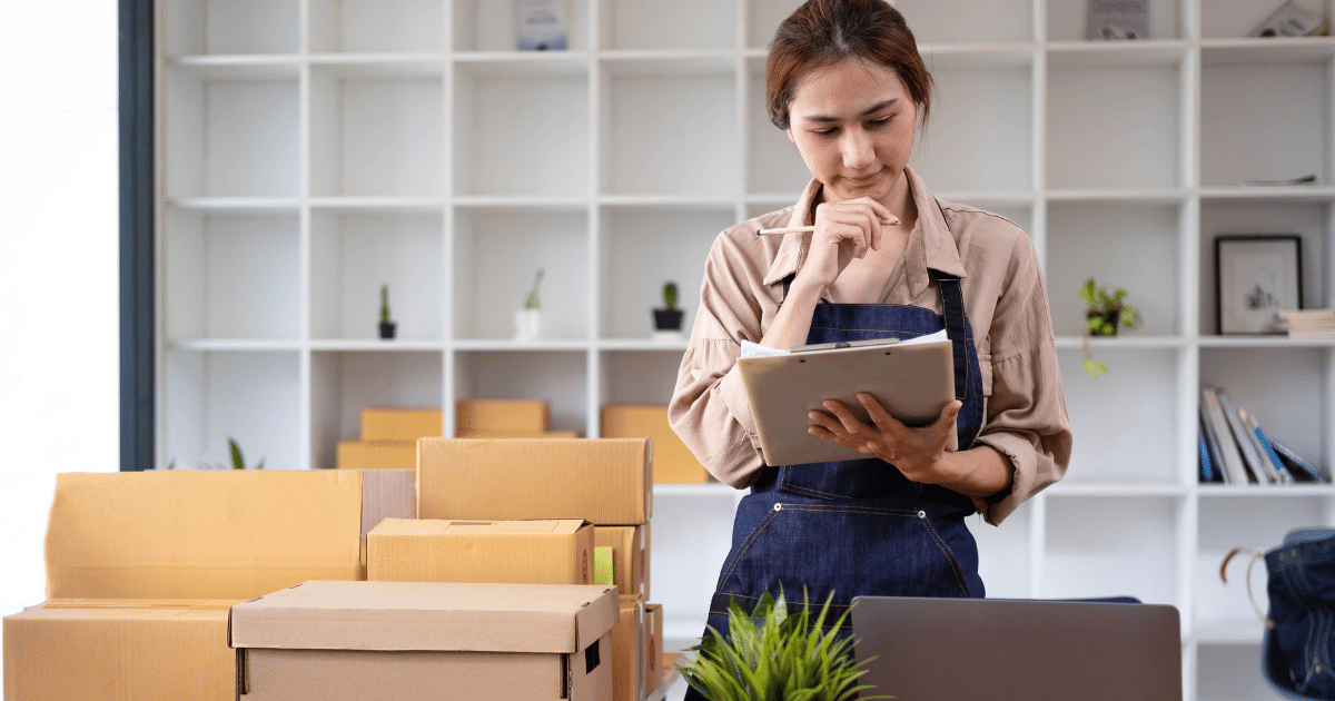 Small business owner managing inventory and finances, exploring options for tax liabilities with a business line of credit.