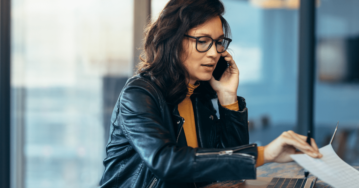 Businesswoman on phone discussing financial solutions for small and medium businesses with bad credit.