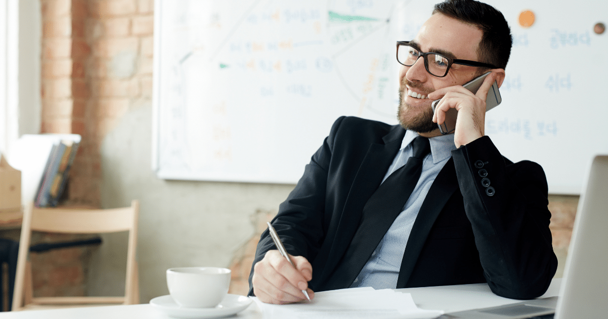 Business professional managing time effectively while on a phone call, emphasizing time management strategies.