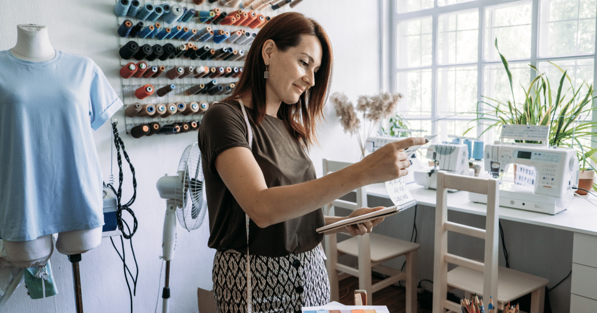 Business owner evaluating financing options in a creative workspace, considering loans and lines of credit for growth.