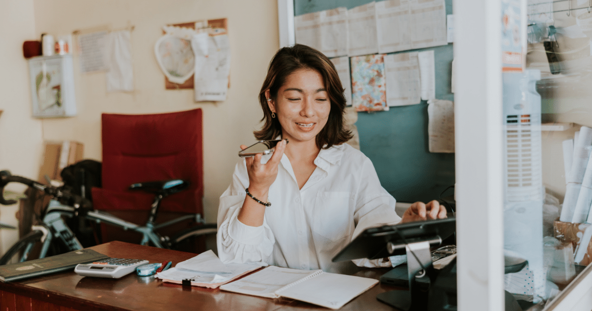 Woman entrepreneur managing her small business, using technology and planning for success in a supportive environment.