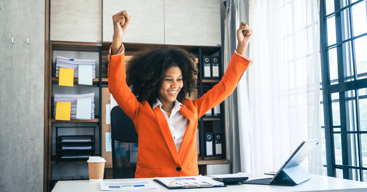 Business owner celebrating success in an office, representing growth and hiring with Advance Funds Network.