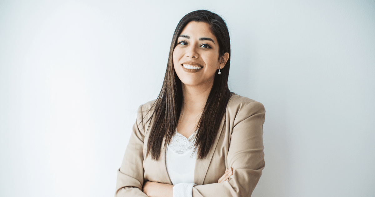 Smiling businesswoman in a blazer, representing entrepreneurship and business success strategies.