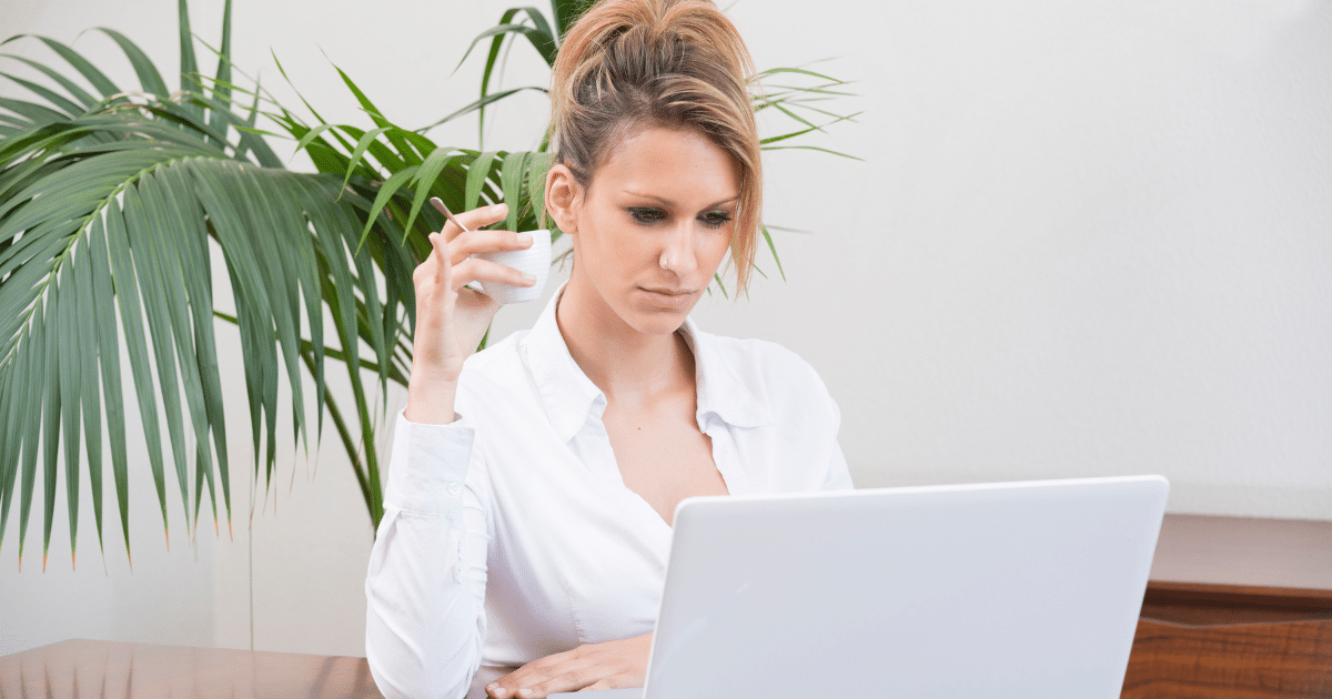 Businesswoman analyzing lease options on a laptop, highlighting operating vs. capital leases for financial decisions.