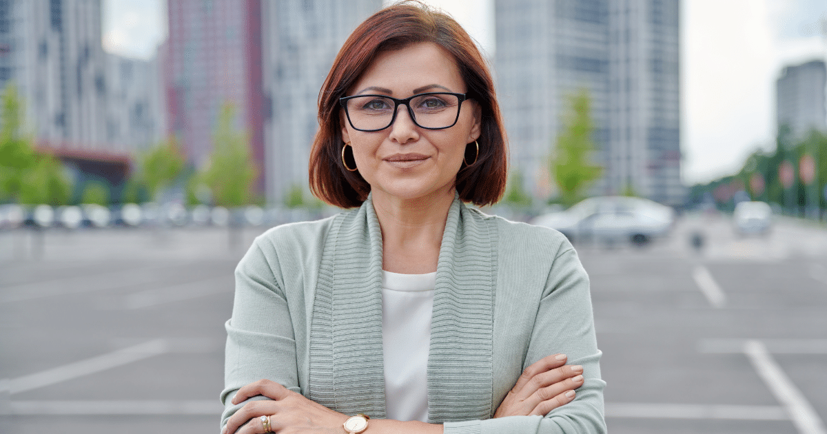 Confident businesswoman in urban setting, representing expert tips for business loan approval and financial growth.