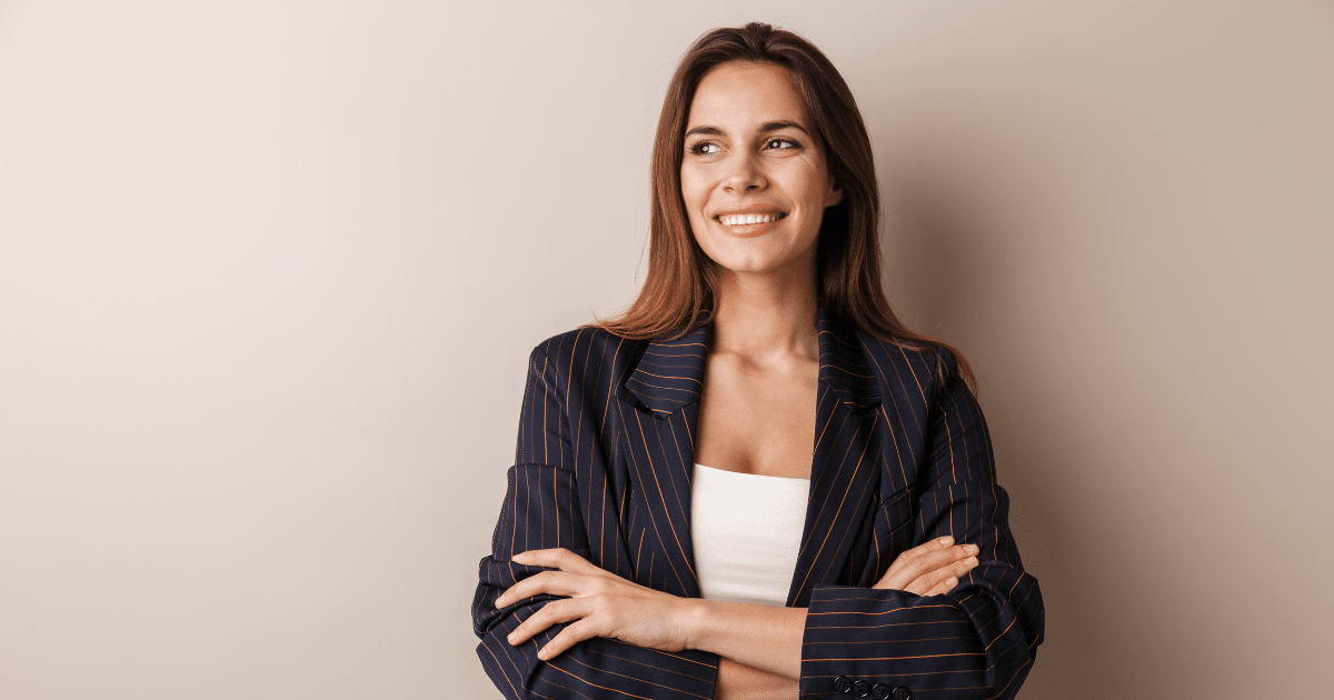 Smiling businesswoman in a striped blazer promoting a paperless office transition for small businesses.