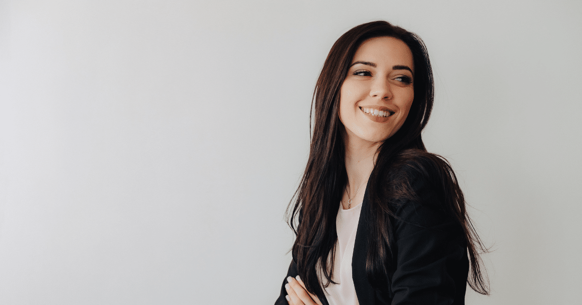 Smiling businesswoman in a blazer, representing effective email marketing strategies for small businesses.