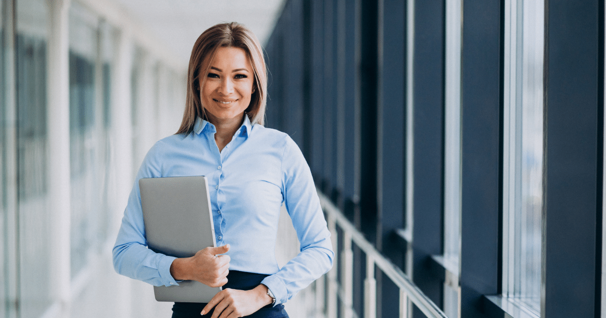 Professional woman holding a laptop, representing mobile marketing strategies for business success and local SEO optimization.