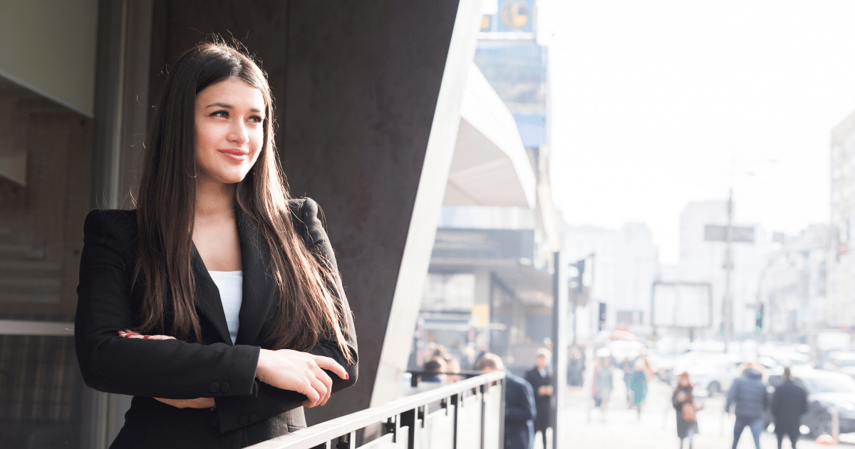 Businesswoman exploring small business financing solutions in a bustling urban environment, showcasing confidence and opportunity.
