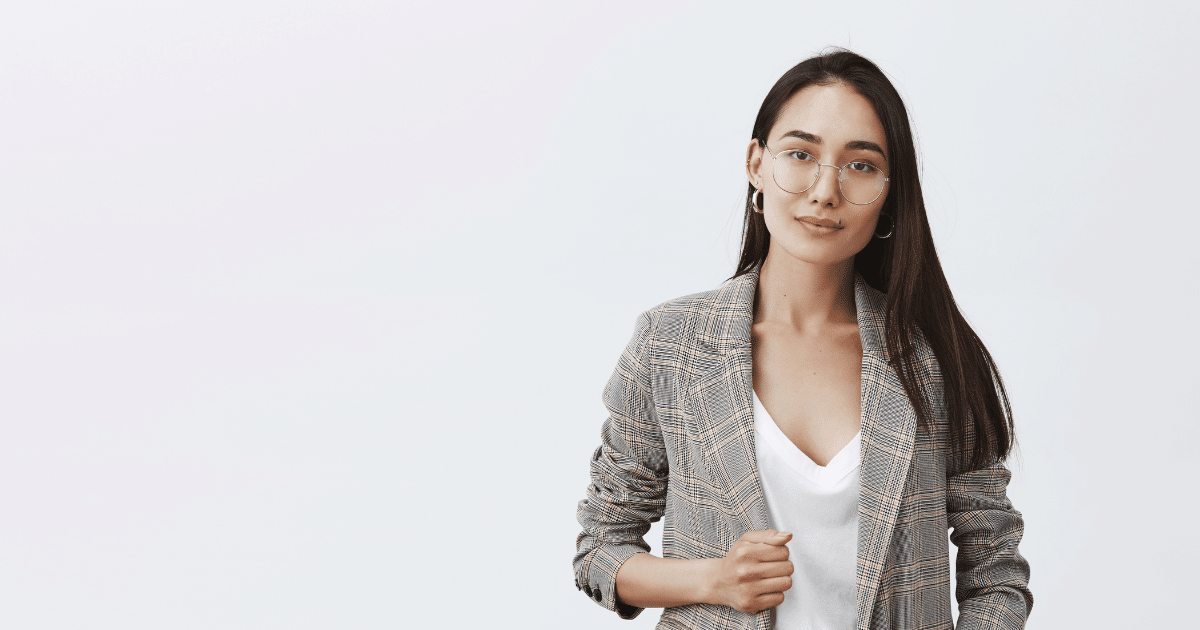 Professional woman in a blazer, representing key business practices for small business owners and effective communication skills.