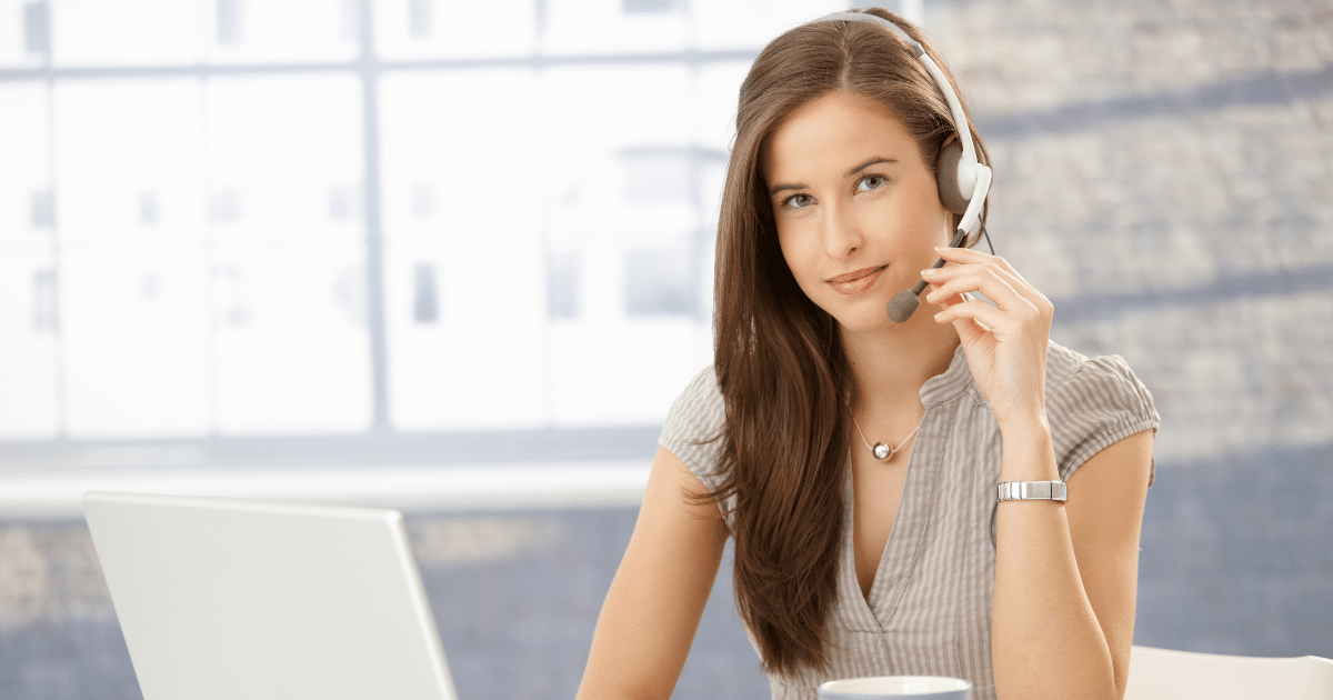 Office employee with headset providing support, enhancing workplace morale and productivity through effective communication.