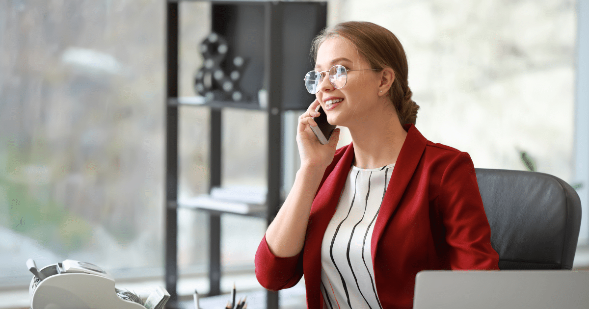 Professional woman on the phone in a modern office, representing business growth and customer service excellence.