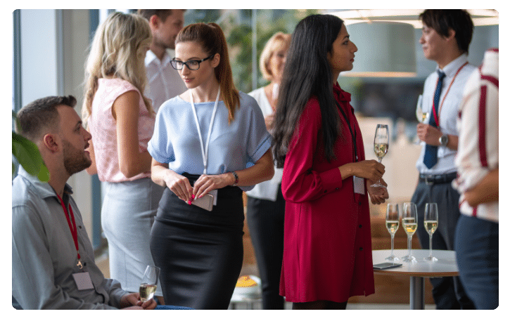 Networking event with professionals engaging in conversation, showcasing effective small business networking strategies.