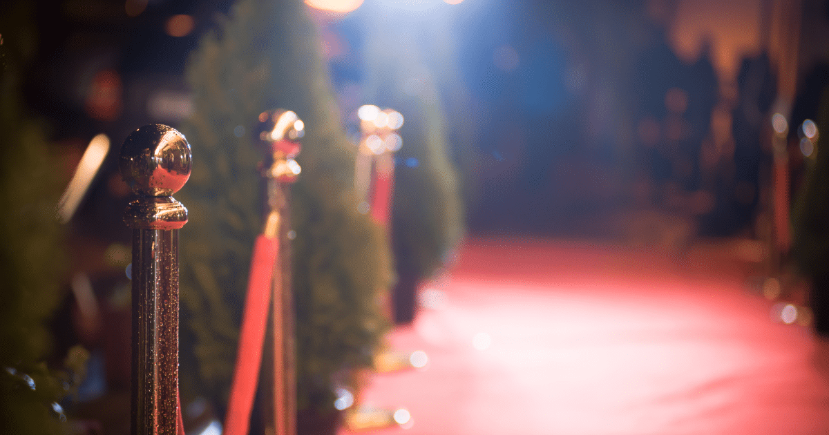 Red carpet event with stanchions, symbolizing celebrity success and business lessons from top entrepreneurs.