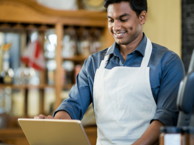 Business owner managing finances with an unsecured line of credit for growth and stability in a hardware store.