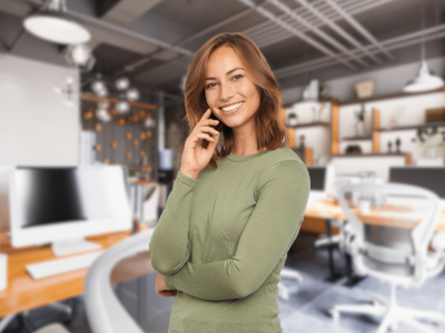 Smiling woman in a modern office, representing business financing and support for entrepreneurs and small businesses.