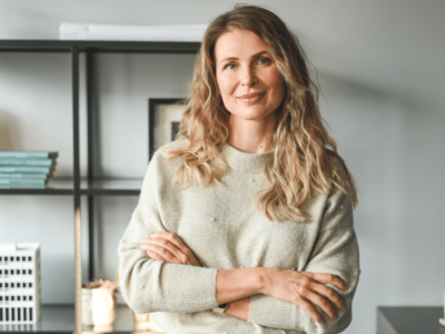 Businesswoman evaluating flexible credit options for real estate investment amidst boxes in a management office.