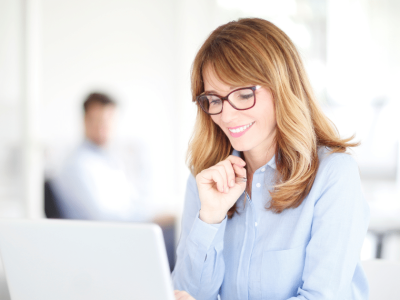 Smiling businesswoman in a clothing store, showcasing affordable financing options for veterinary care loans.