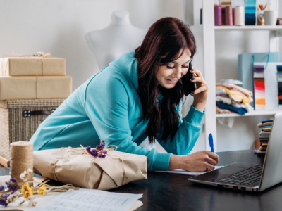 Smiling woman in a red blazer representing effective customer engagement strategies for small businesses.
