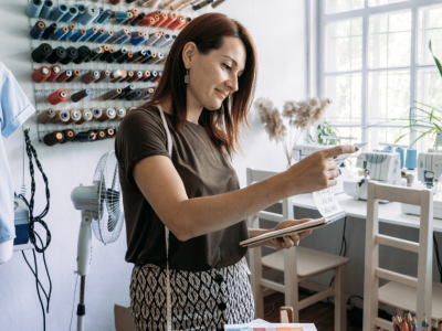 Business owner evaluating financing options in a creative workspace, considering loans and lines of credit for growth.