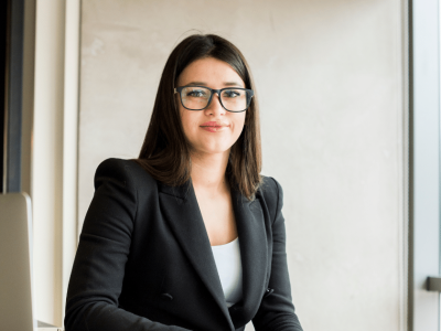 Smiling business owner in an apron, showcasing social media marketing potential for small businesses.
