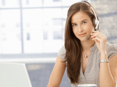 Office employee with headset providing support, enhancing workplace morale and productivity through effective communication.