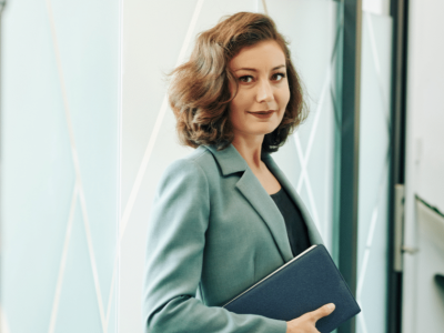 Woman managing her small business finances with packages and laptop, highlighting unsecured business loan eligibility.
