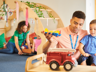 Child day care provider engaging with children, showcasing flexible bad credit business loans for child care services.